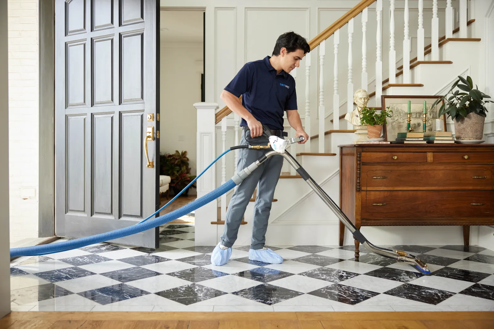 black and white tile being cleaned by a professional tile and grout cleaner