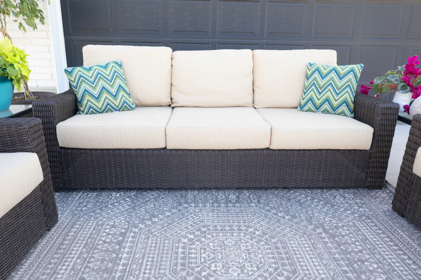 patio furniture with pillows and a rug