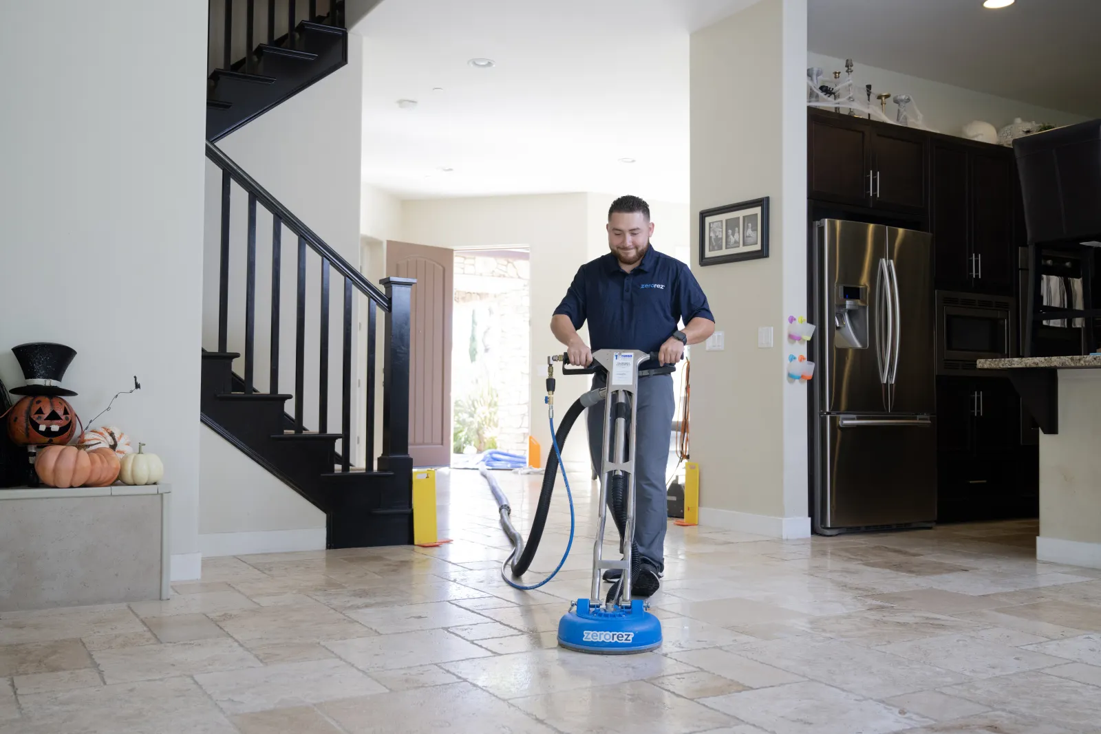 zerorez technician cleaning tile in a kitchen in a home