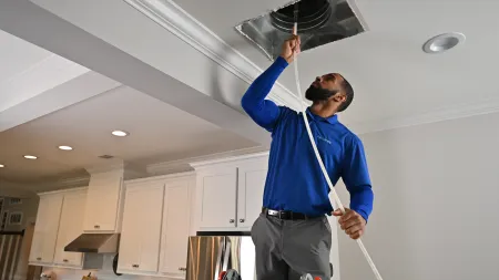 a man cleaning the air ducts in a home