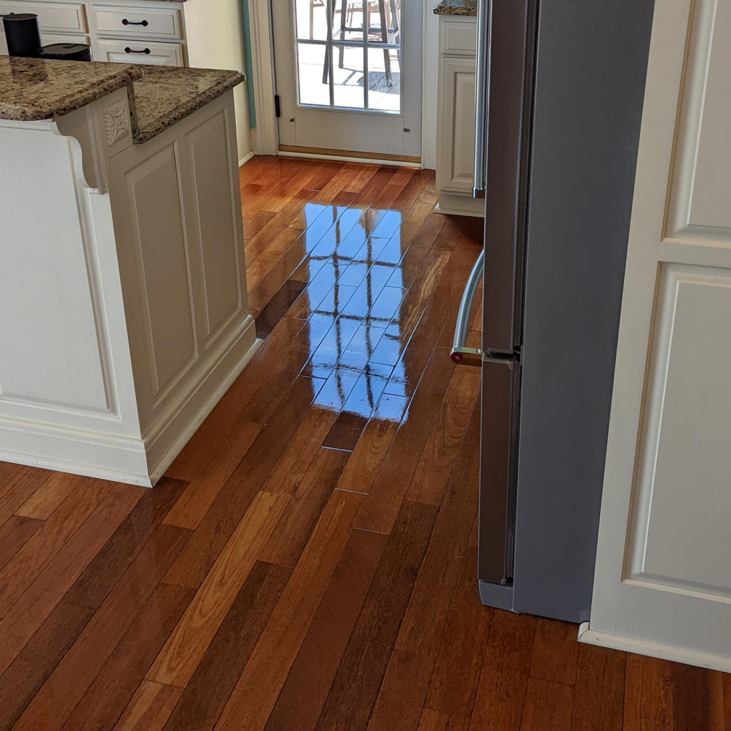 Shiny hardwood floor that isn't slippery in a kitchen after being professionally cleaned by Zerorez&reg;